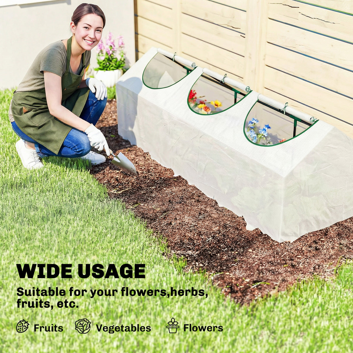 Portable mini greenhouse with white cover and green-trim zip windows during setup