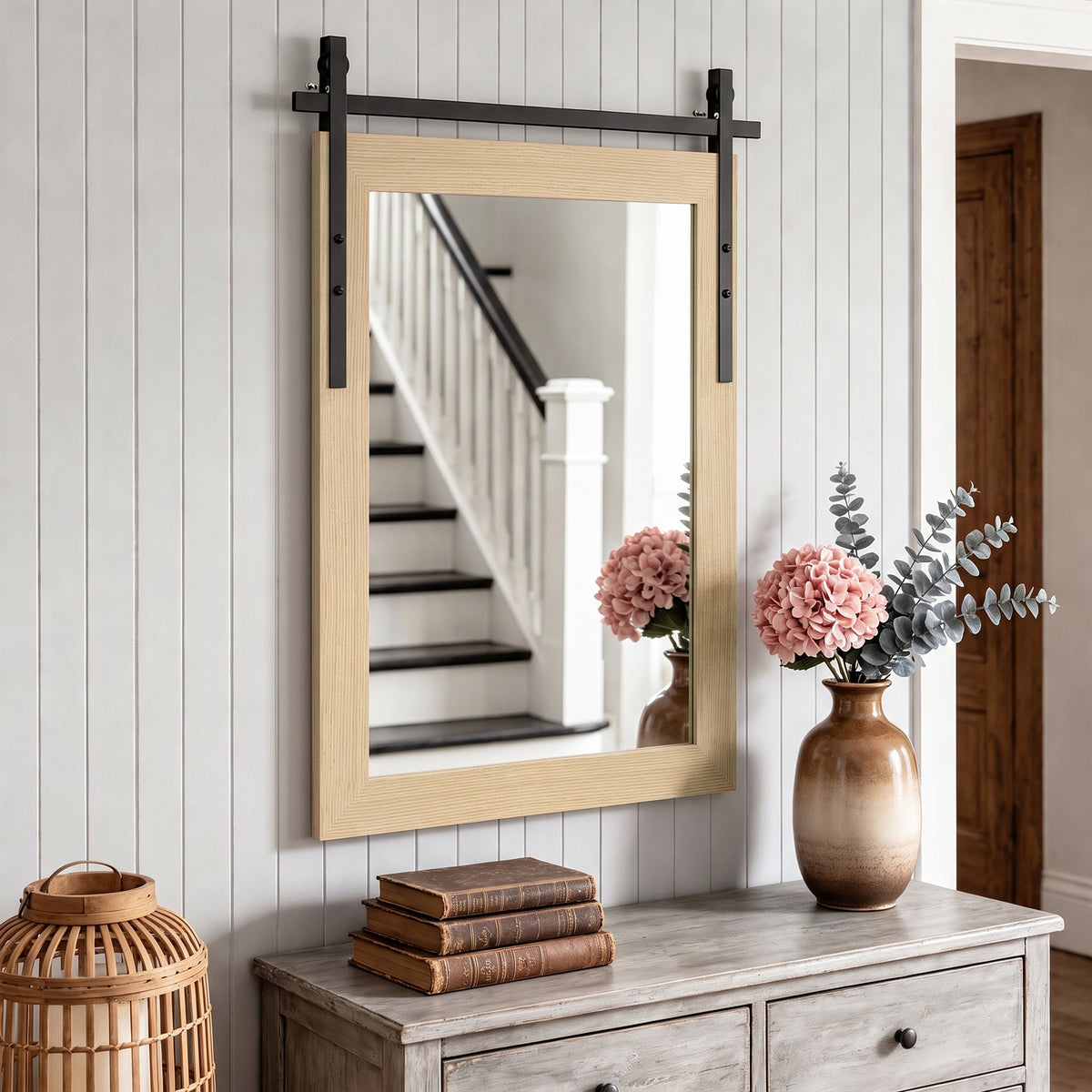 Rectangular wall mirror with light wood frame and black metal support bars