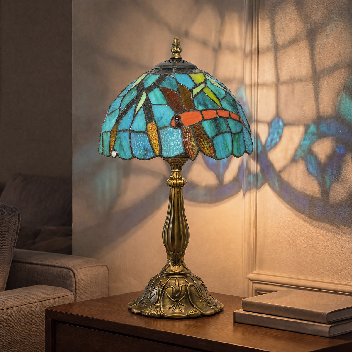 Handmade stained glass table lamp with green-blue shade and ornate brass base.