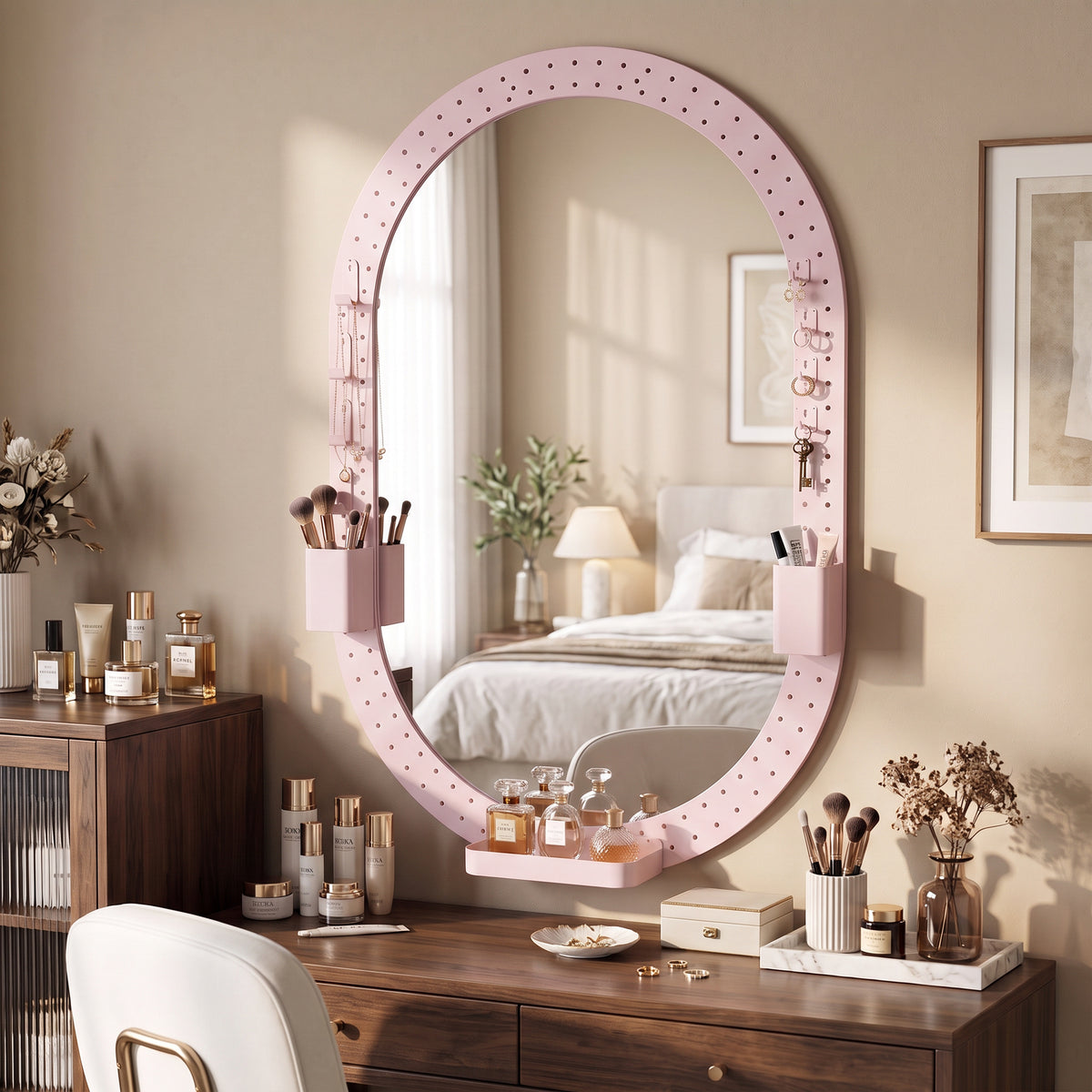 Oval wall mirror with pink pegboard frame hooks for organizing small items