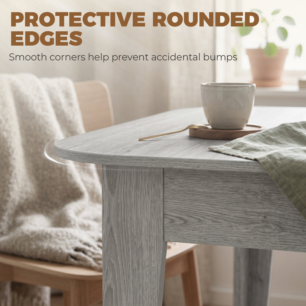 Grey wood-effect extendable oval dining table with protective rounded corners and tabletop edge.