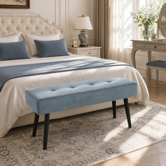 Blue corduroy tufted end-of-bed bench with padded seat and black steel legs