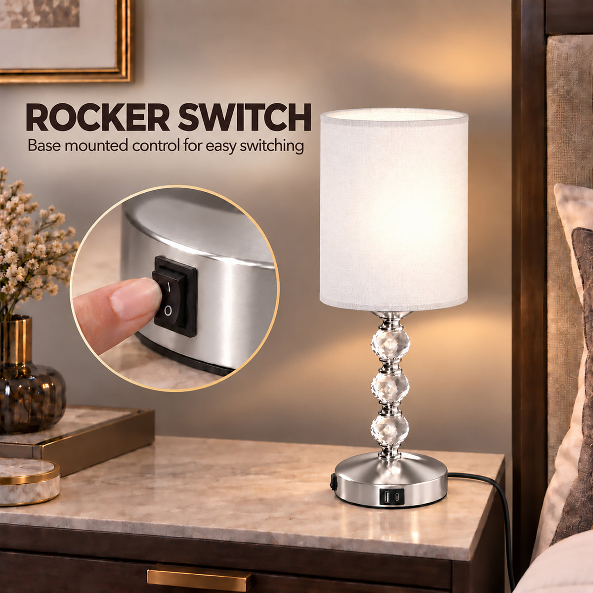Bedside table lamp with white shade, clear crystal column, and rocker power switch