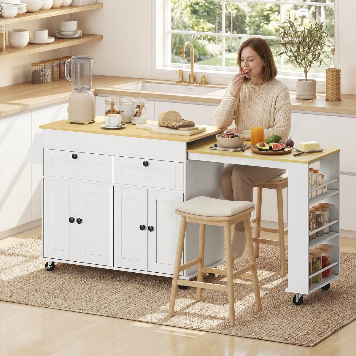 Rolling kitchen island with expandable countertop, white cabinet doors, side shelves and stool.