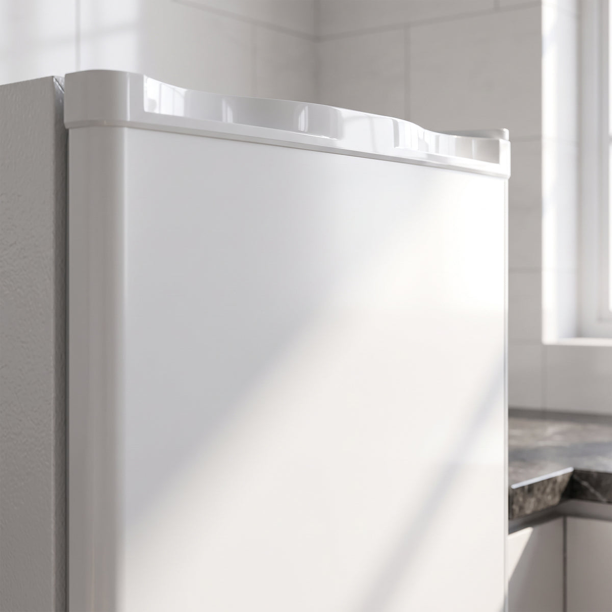 White mini freezer door close-up with top rim and smooth cabinet finish