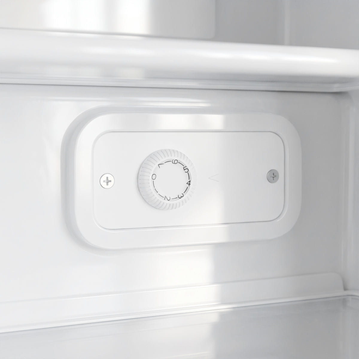 White temperature control dial inside the upright freezer