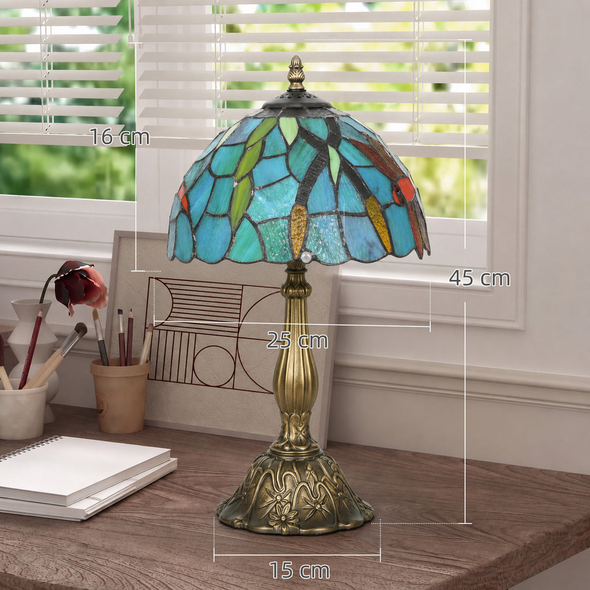 Tiffany-style stained glass table lamp with green-blue shade and brass stand.