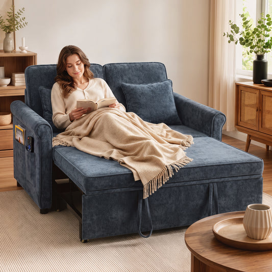 Dark blue chenille sofa bed with three seat cushions and armrests, draped with blanket