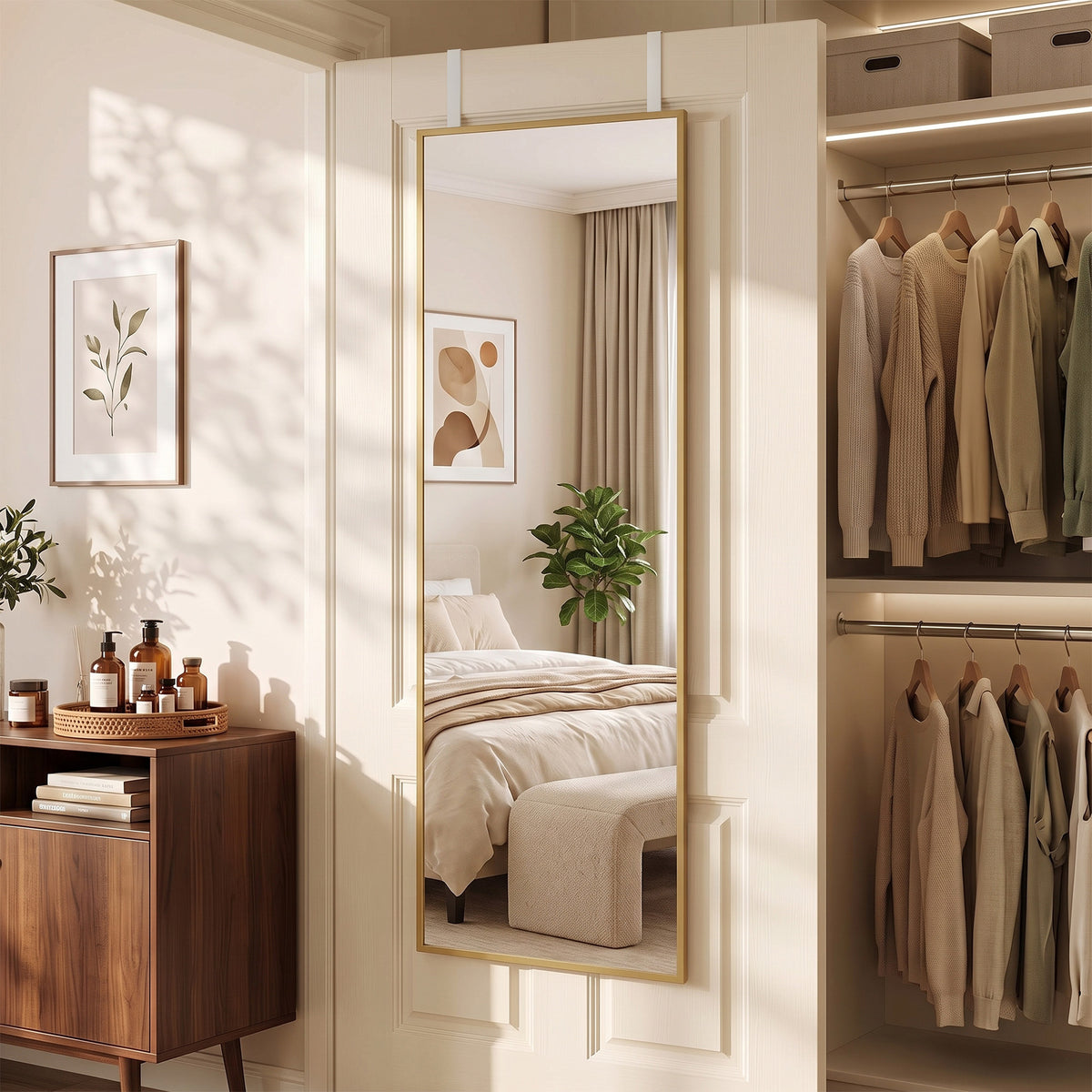 Full length gold-tone framed mirror mounted on a door, reflecting a bedroom