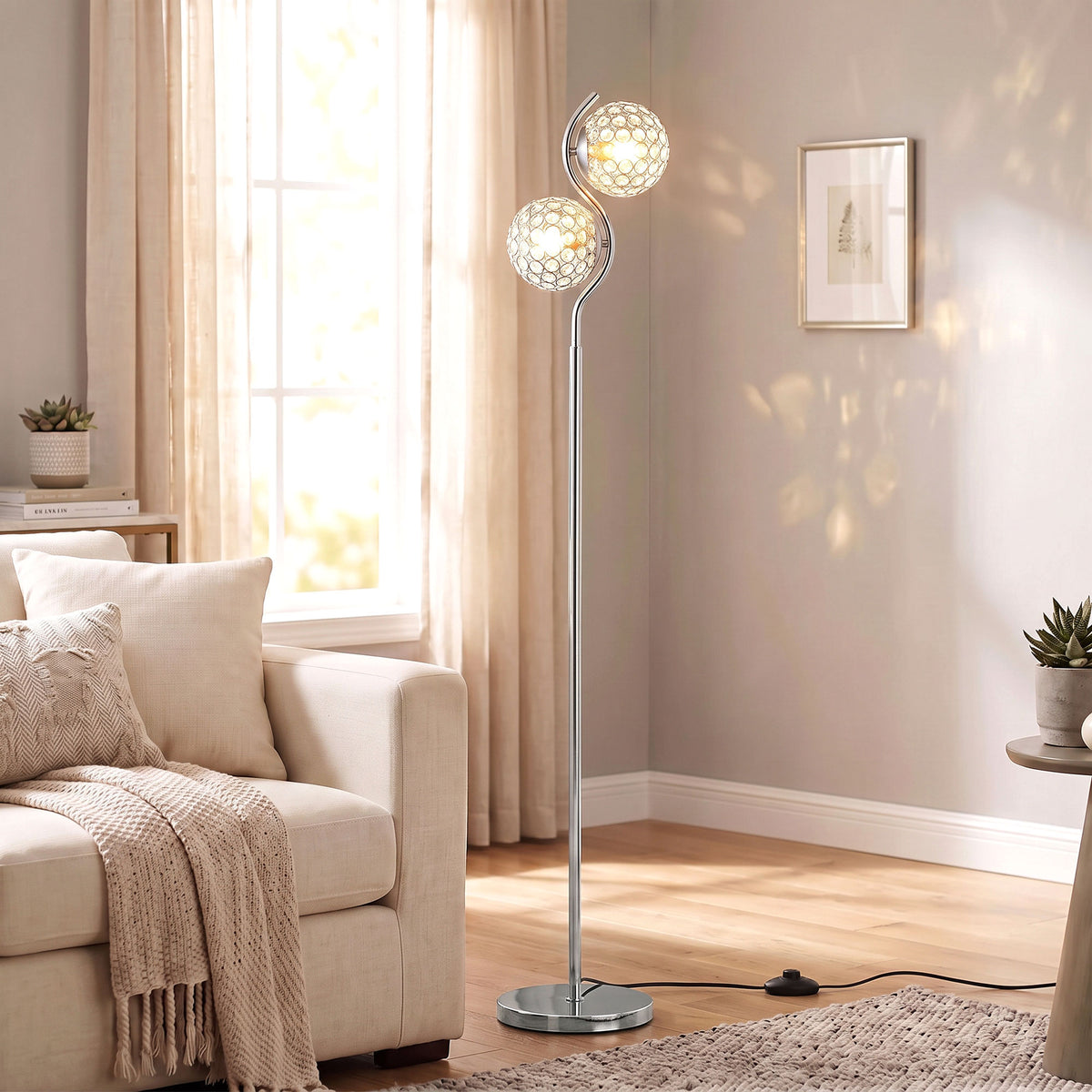 Silver dual-head floor lamp with two crystal globe shades and a round weighted base.