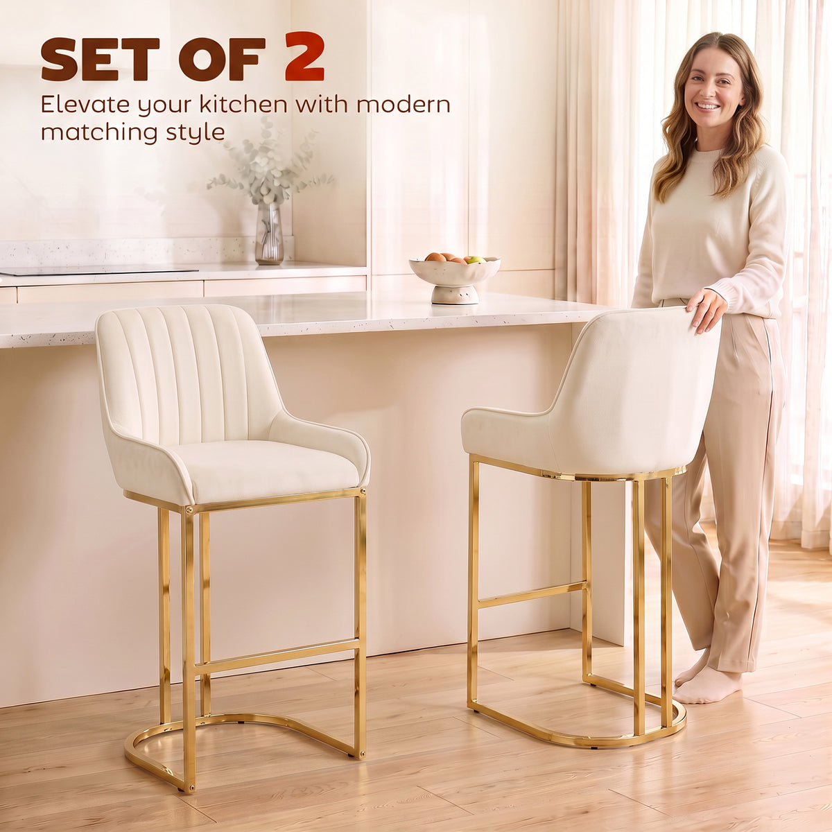 Pair of cream white velvet bar stools with backrest, footrest, and polished gold legs