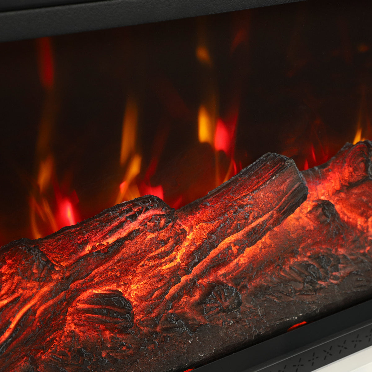 Close-up of electric fireplace faux logs with vivid orange and red flame glow