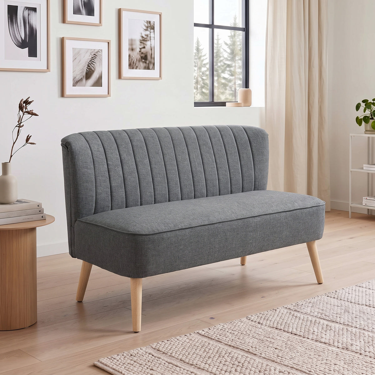 Dark grey 2-seat sofa loveseat with tall channel-tufted back and light wood legs