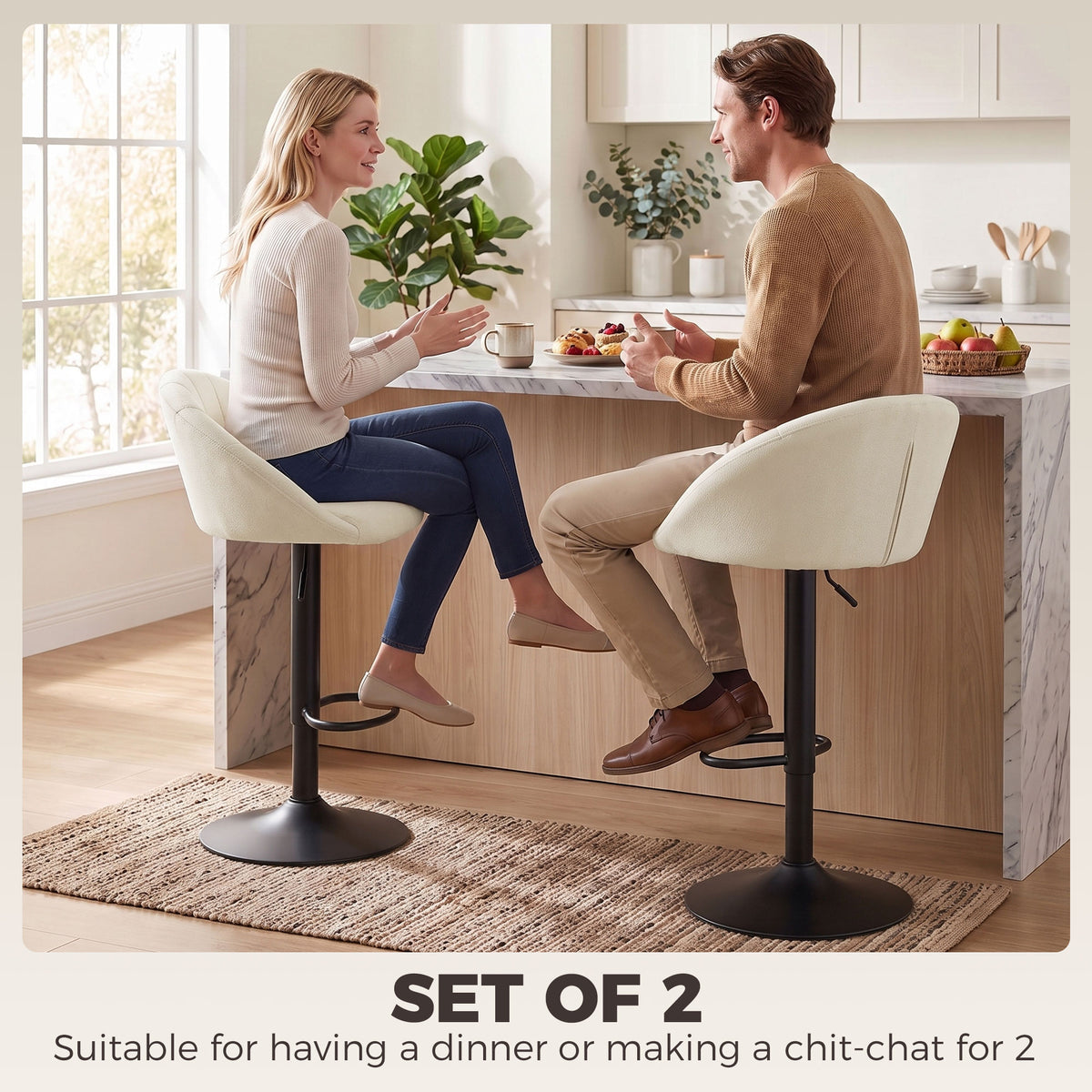 Set of two cream padded swivel bar stools with black bases and footrests for counter seating