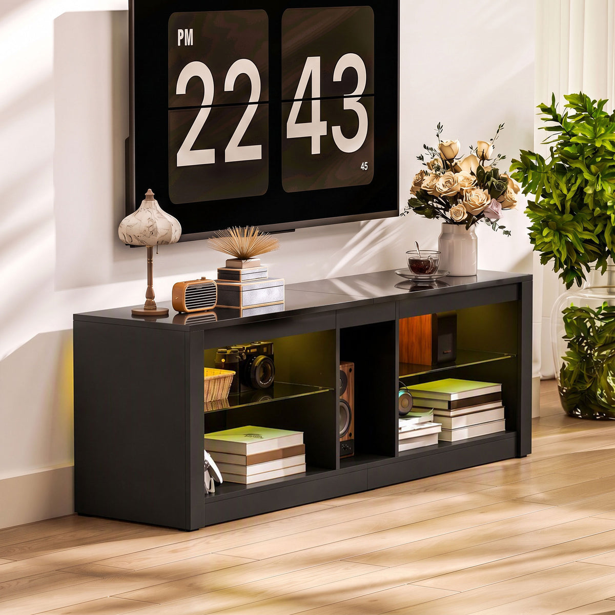 Dark gray TV stand with open cubby storage for books, decor, and electronics