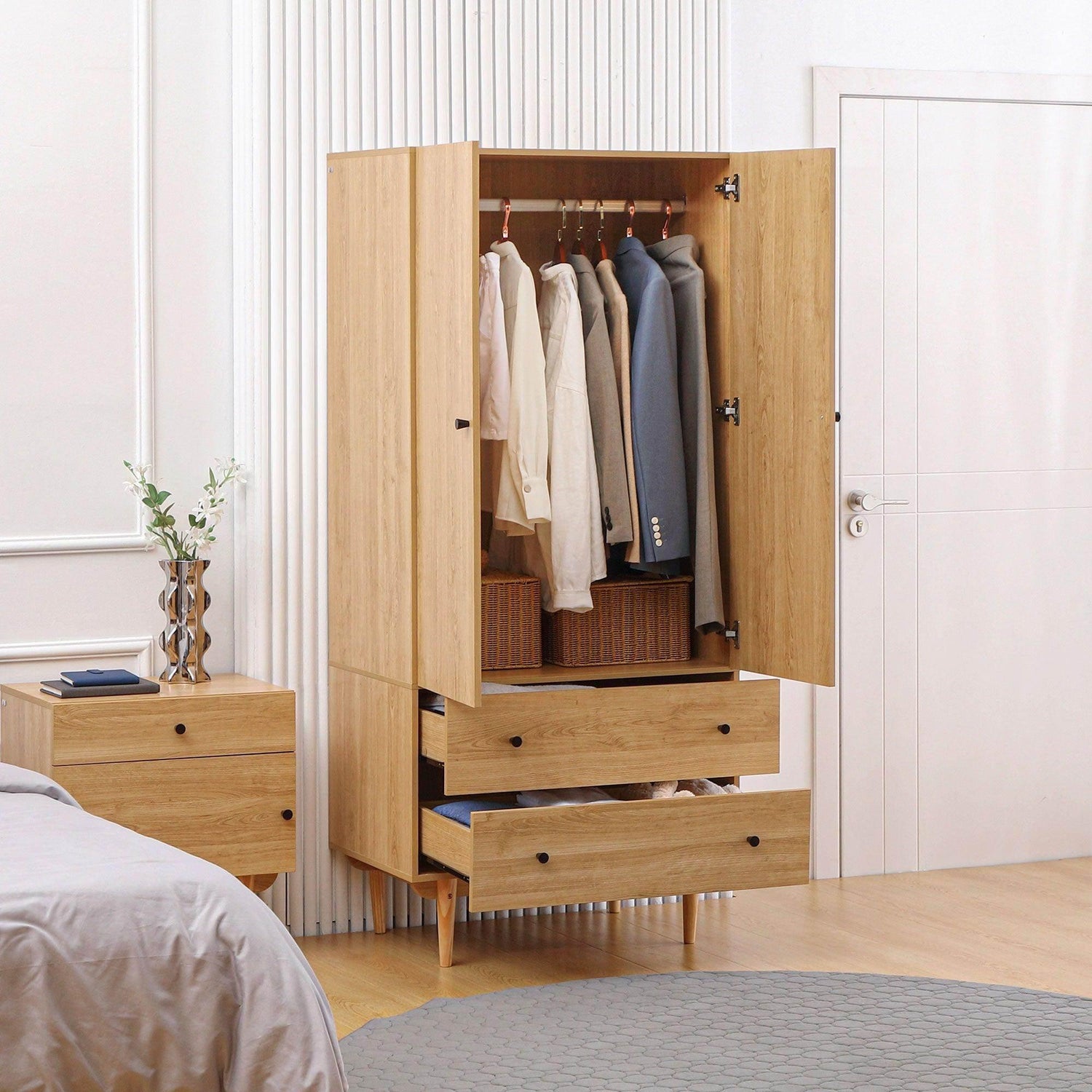 Natural wood wardrobe with two doors, hanging rail, and two drawers