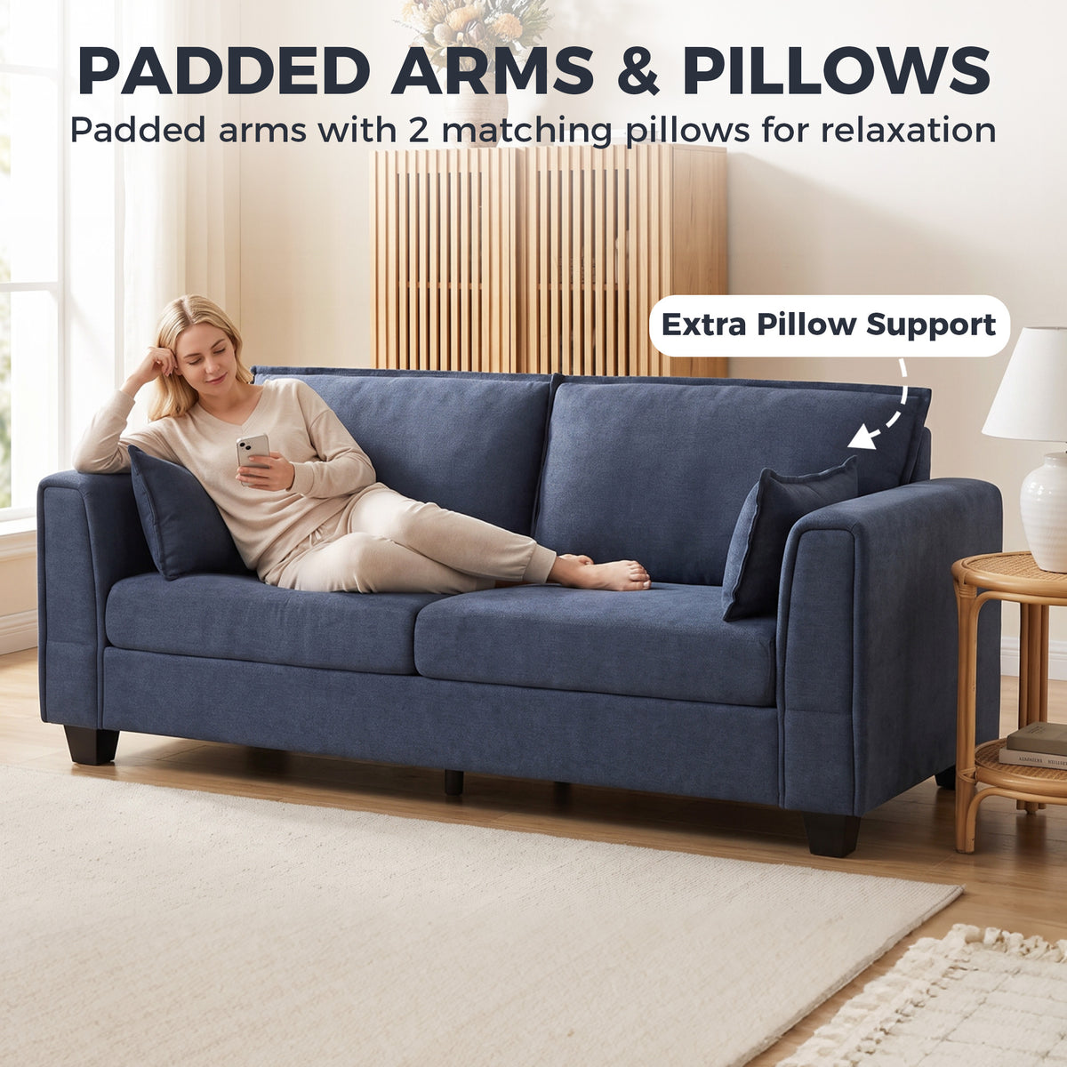 3-seat sofa with padded armrests and dark blue fabric, includes matching throw pillows