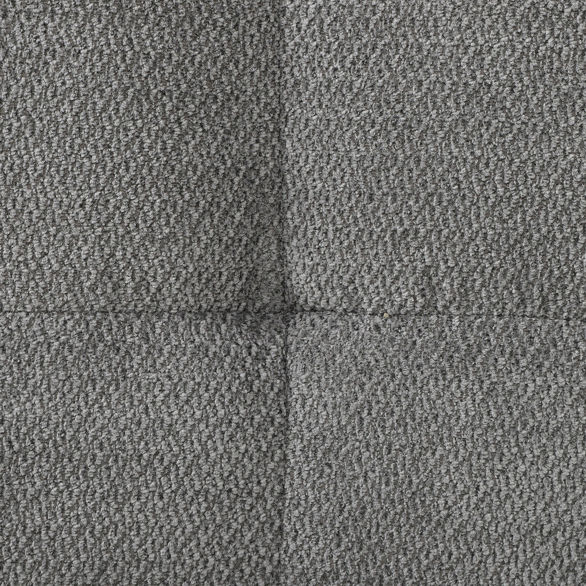 Grey velvet sofa armrest upholstery detail, textured fabric in dark grey.