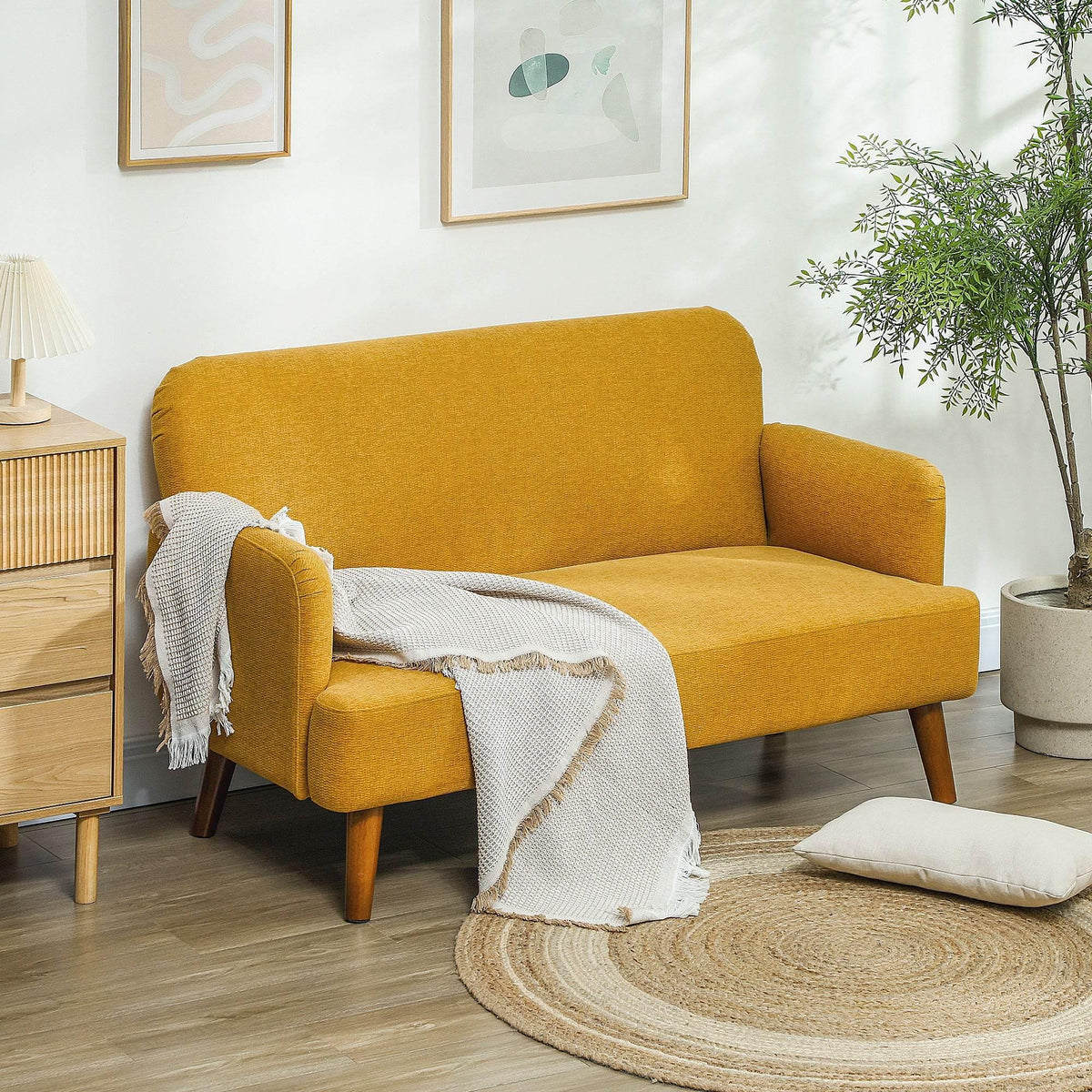 Mustard yellow velvet 2-seater sofa with thick arms and wooden legs