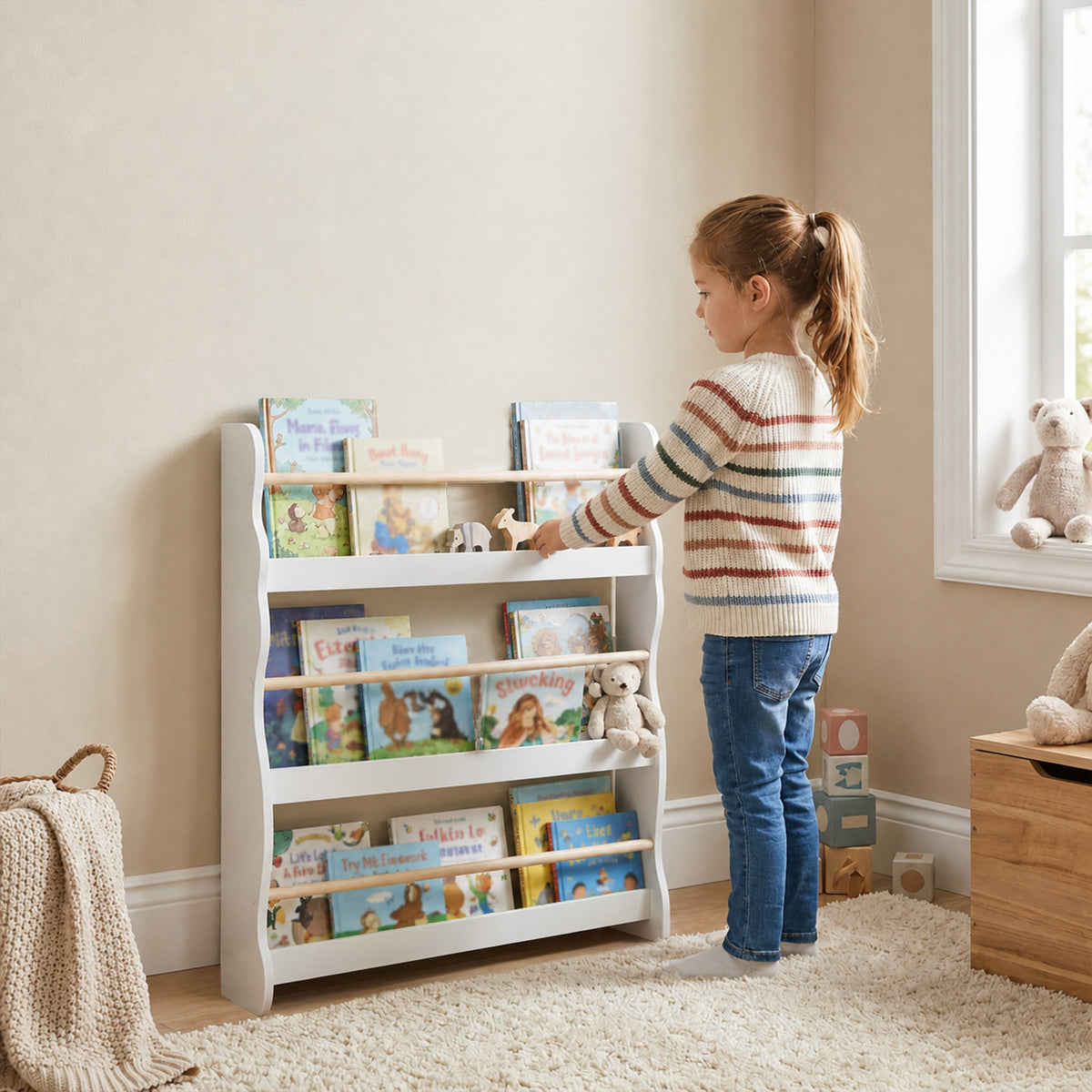 White children’s bookcase with open shelves, front lip, and side cutout supports