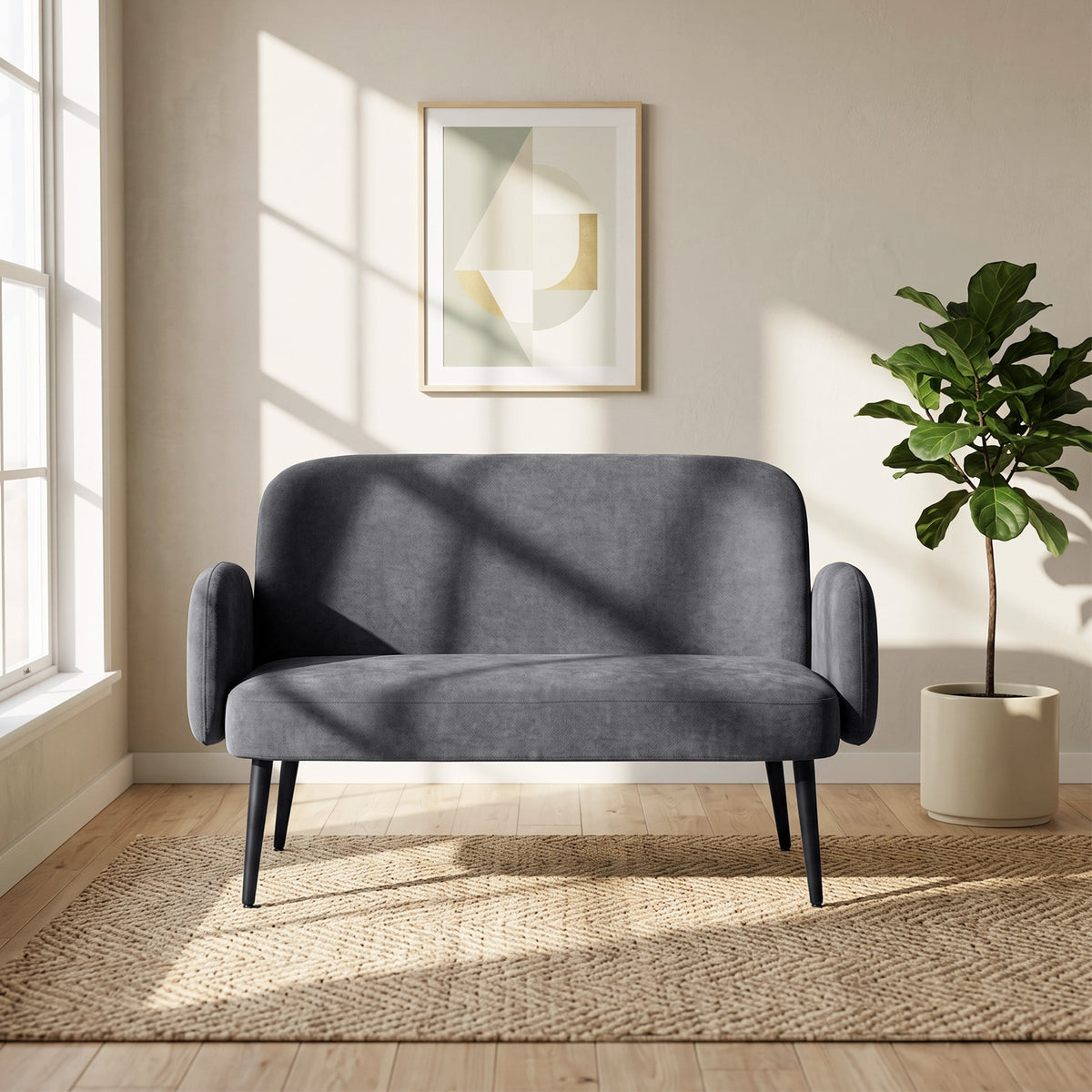 Dark grey velvet loveseat with rounded arms and tapered legs