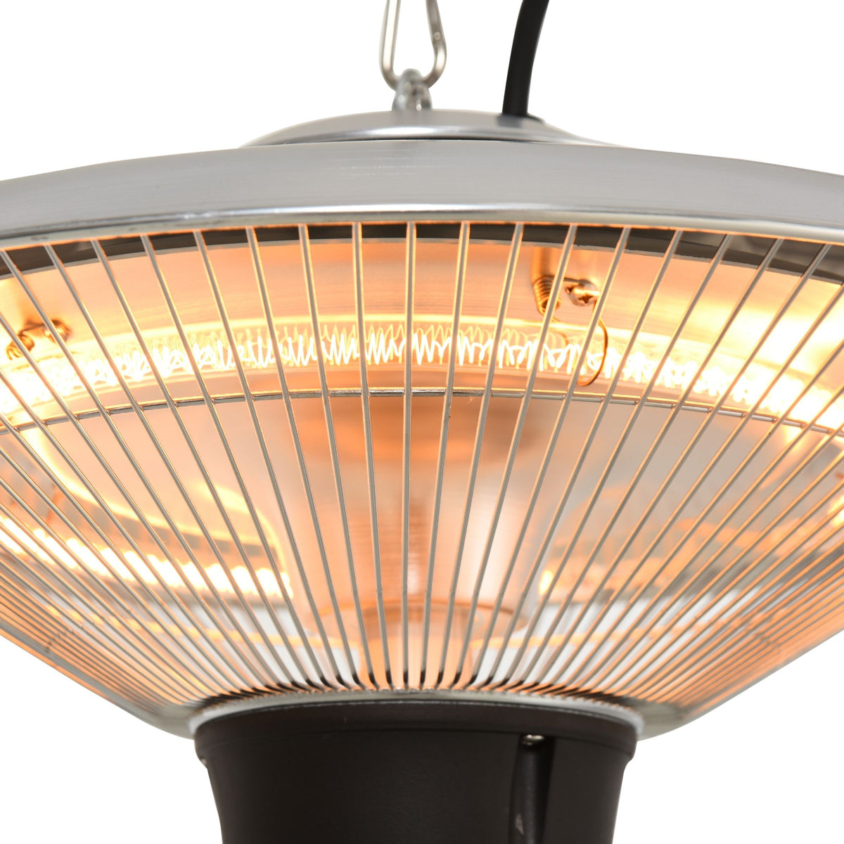 Close-up of halogen heater metal mesh reflector and glowing heating element