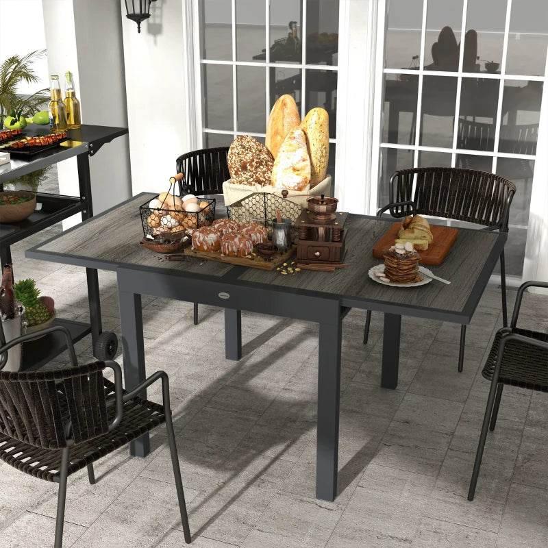 Grey rectangular outdoor patio table with wood-look tabletop and metal frame