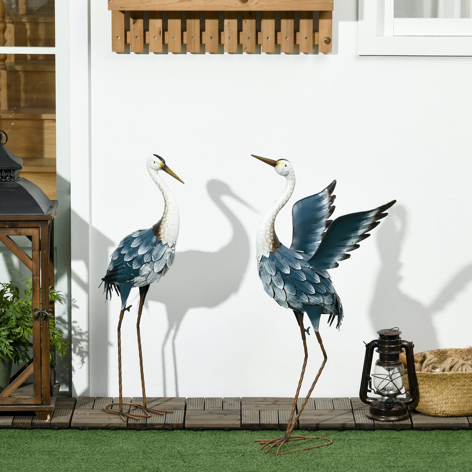 Set of two heron garden statues in blue and white metal with ground stakes