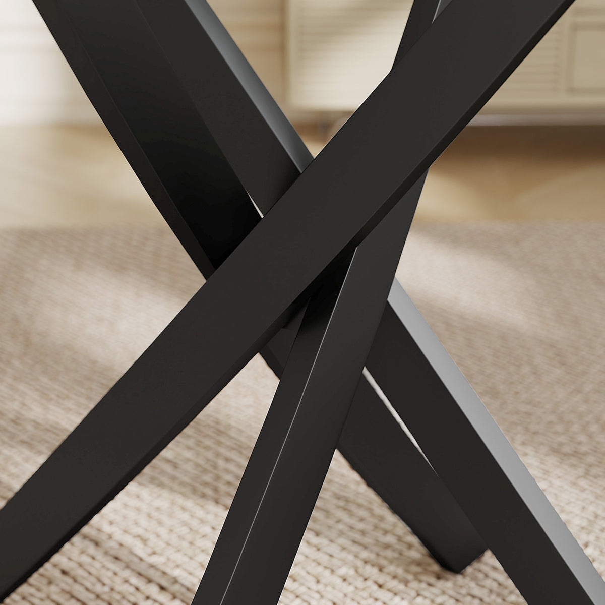 Black X-shaped steel dining table base under clear glass tabletop