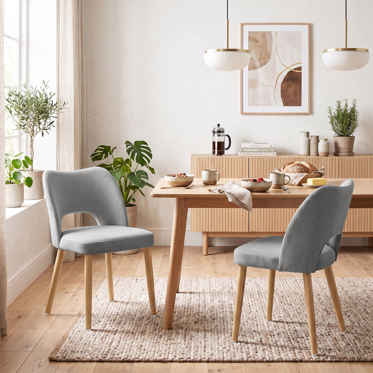 Set of 2 grey chenille dining chairs with rounded backs and angled wood legs
