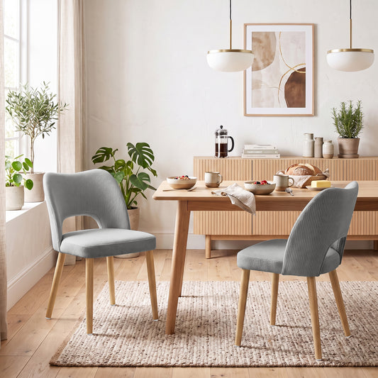 Set of 2 grey chenille dining chairs with rounded backs and angled wood legs