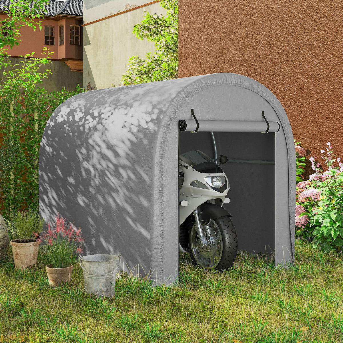 Gray waterproof storage tent with arched entrance, motorcycle visible inside on outdoor grass.