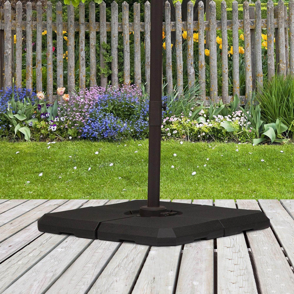 Outsunny black umbrella base with central pole opening, on outdoor deck