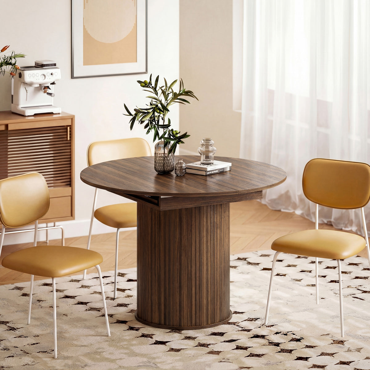 Round dining table with dark wood top and pedestal base, styled with upholstered chairs