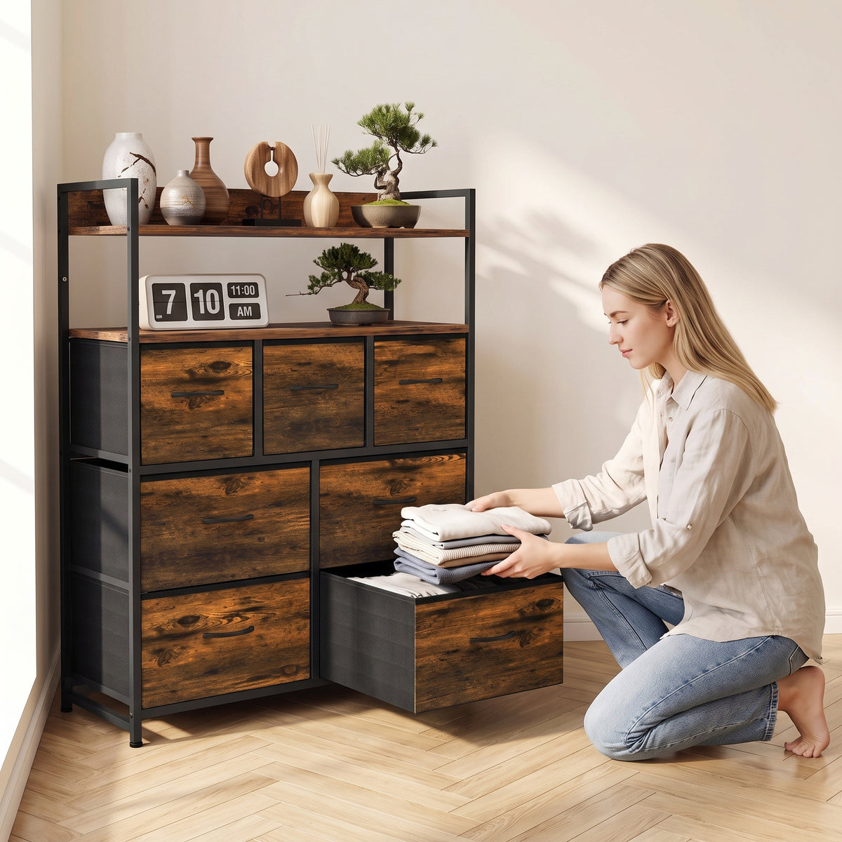 Rustic brown dresser with open shelves and drawers, with person organizing linens