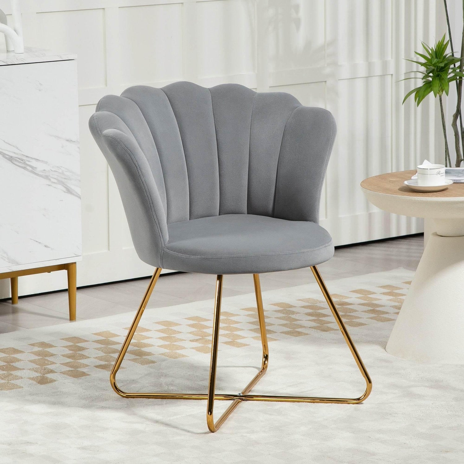 Grey velvet accent chair with lotus petal tufted back and gold cross legs