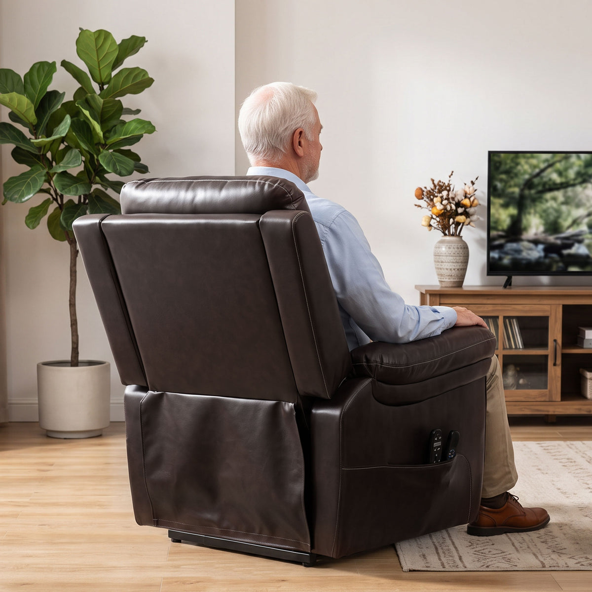 Brown electric lift recliner chair back view with person seated reclined.
