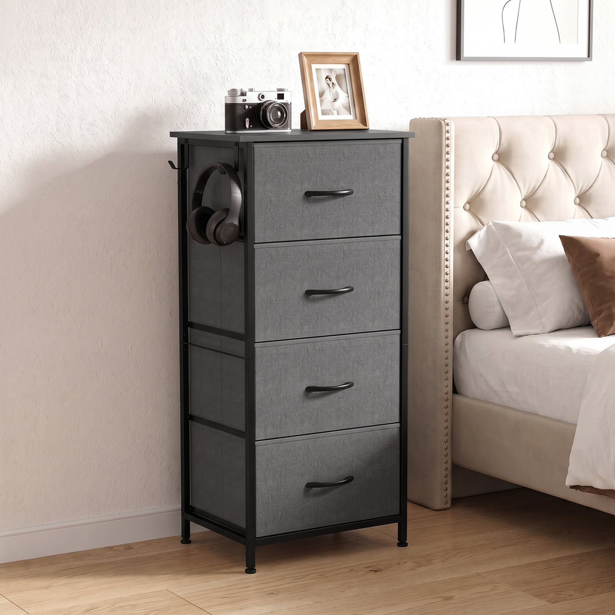 Grey fabric dresser with four drawers and black steel legs, styled in a bedroom corner