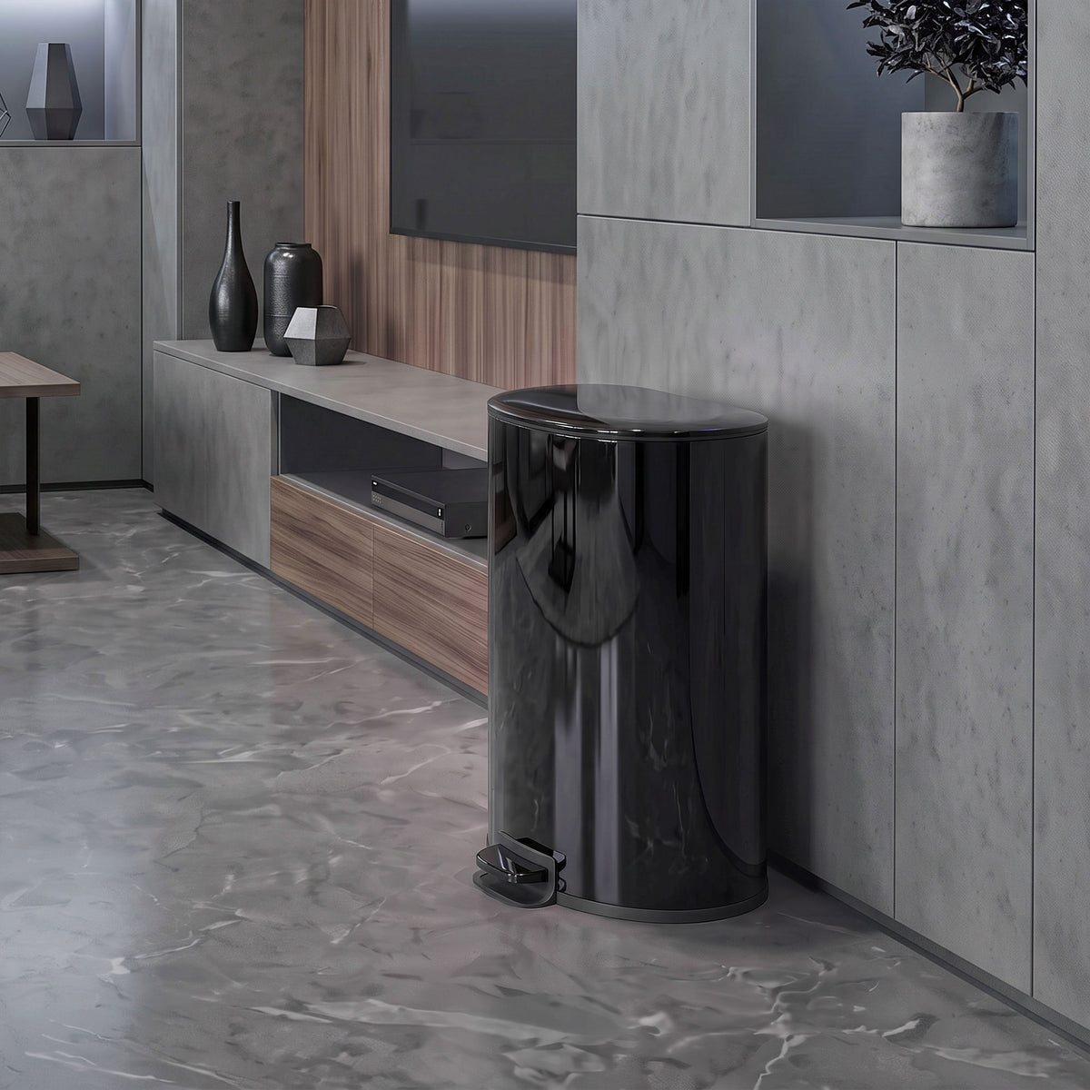 Black stainless-steel round kitchen pedal bin standing beside kitchen cabinets