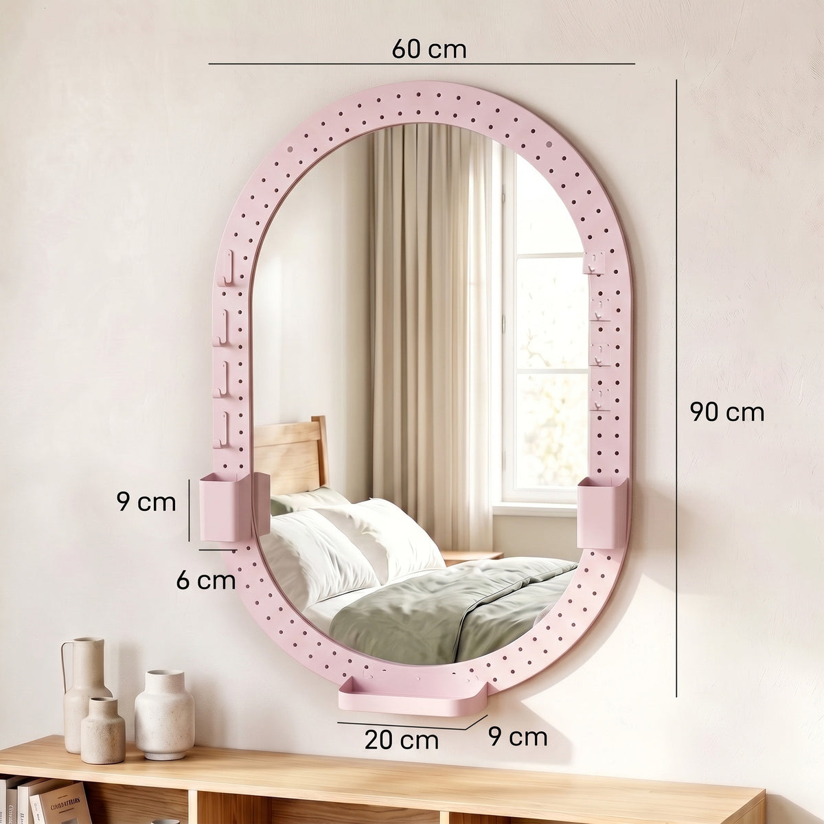 Pink oval wall mirror, 60 cm wide and 90 cm tall, with pegboard frame