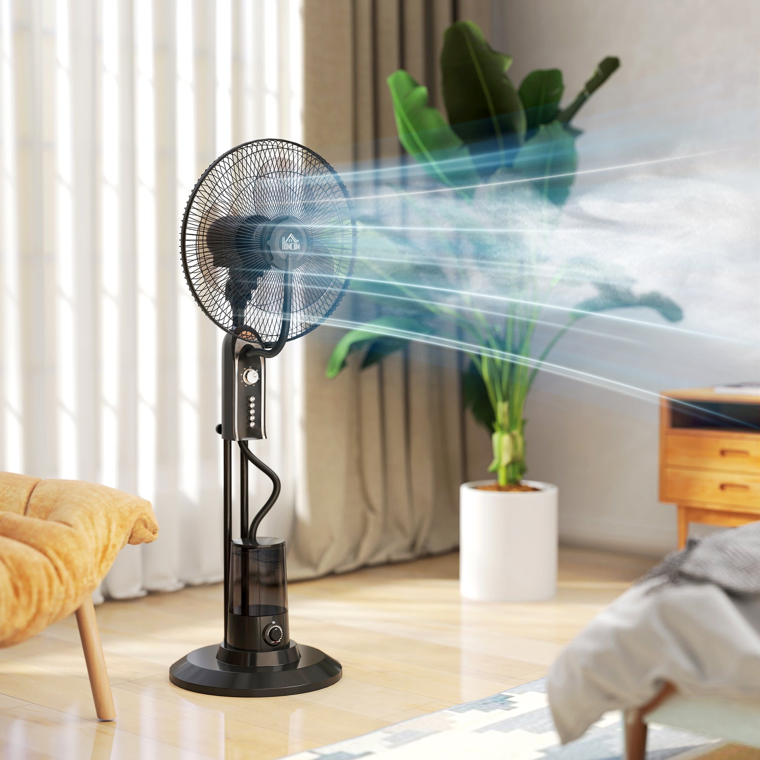 Black pedestal mist fan with protective grille, blowing visible water mist