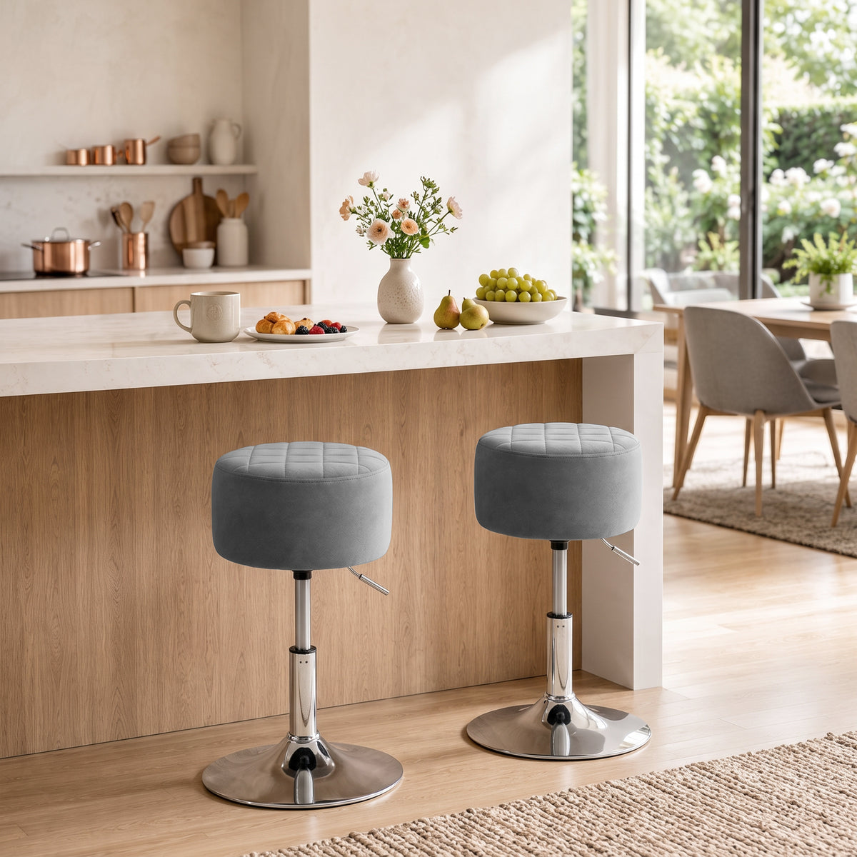 Grey adjustable swivel bar stool with cushioned round seat and chrome footrest base