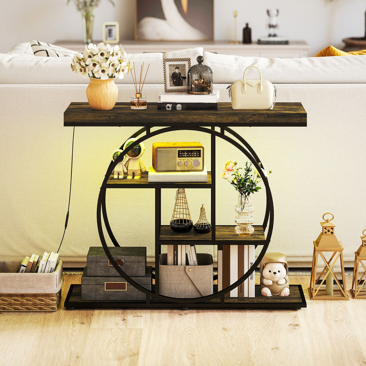 Industrial console table with circular metal base, dark wood top, open storage shelves.