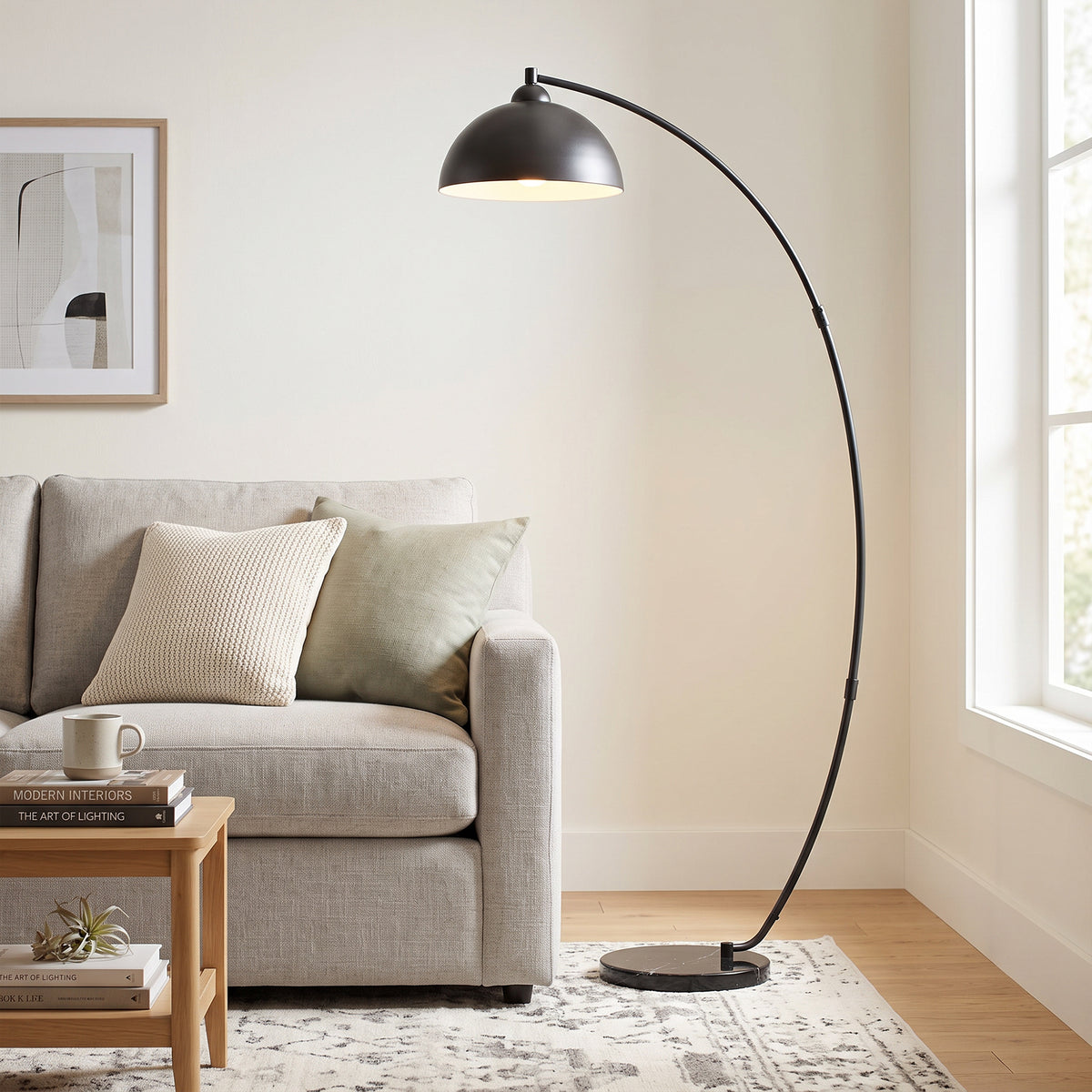 Black arc floor lamp with bowl-shaped shade and circular base