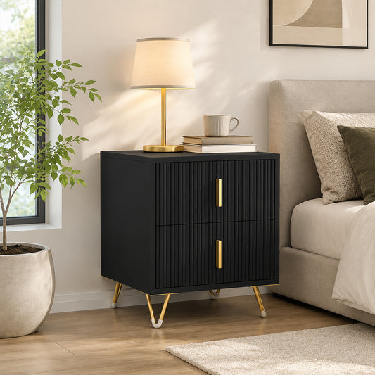Black fluted bedside table with two drawers, gold bar handles, and gold tapered legs