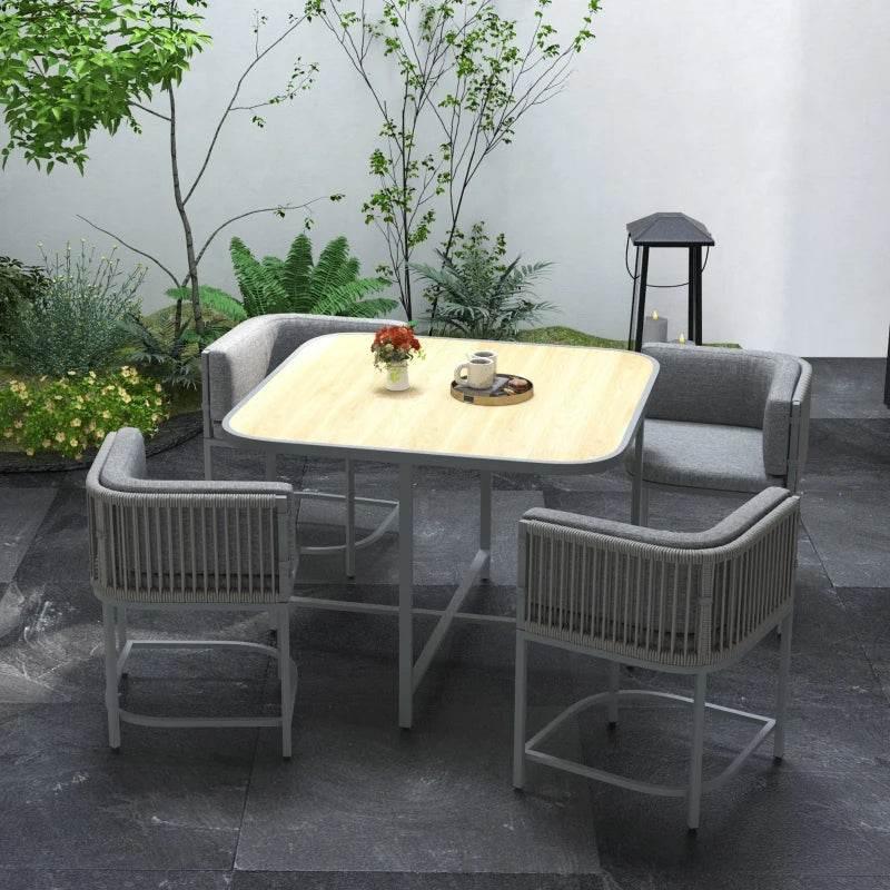 Grey rattan-style outdoor dining set with square table and cushioned cube chairs