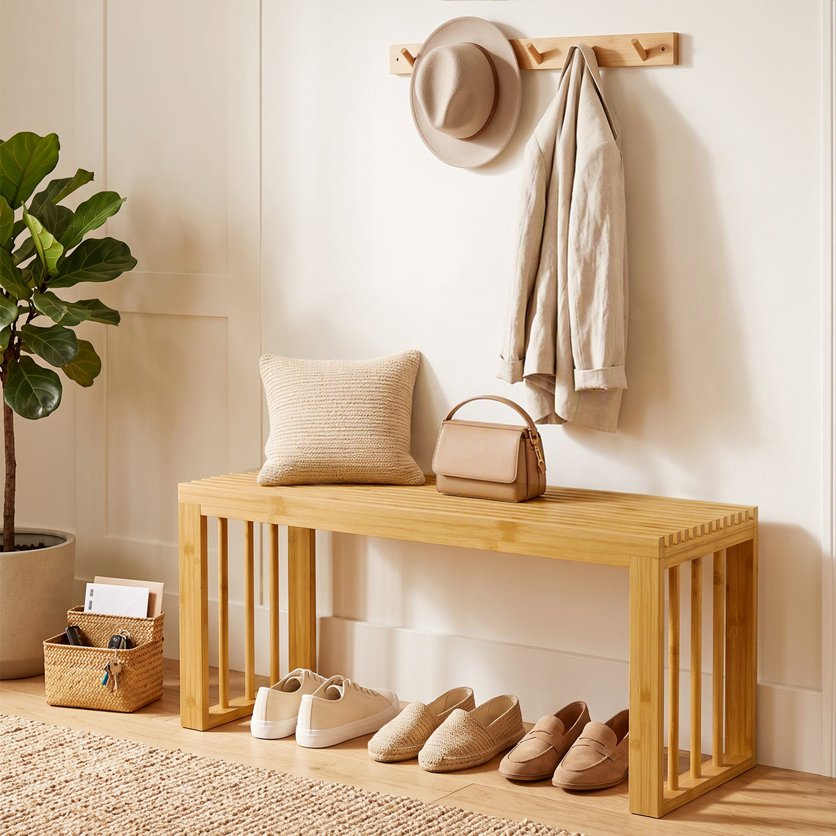 Natural bamboo shoe bench with slatted seat, open sides, and shoes placed on front