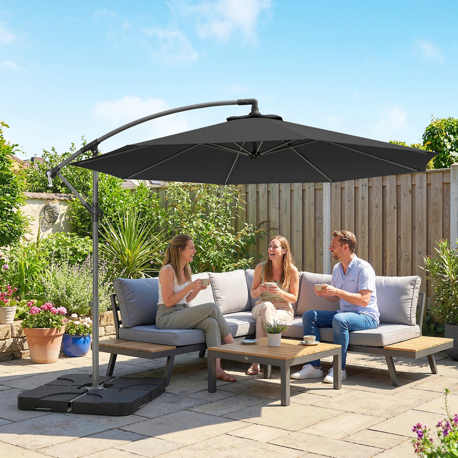 Black cantilever patio umbrella with overhanging canopy and weighted base for outdoor use