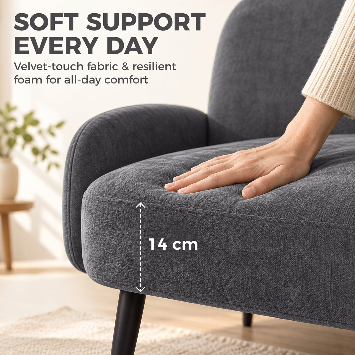 Dark grey upholstered armrest with rounded edge and tapered metal leg