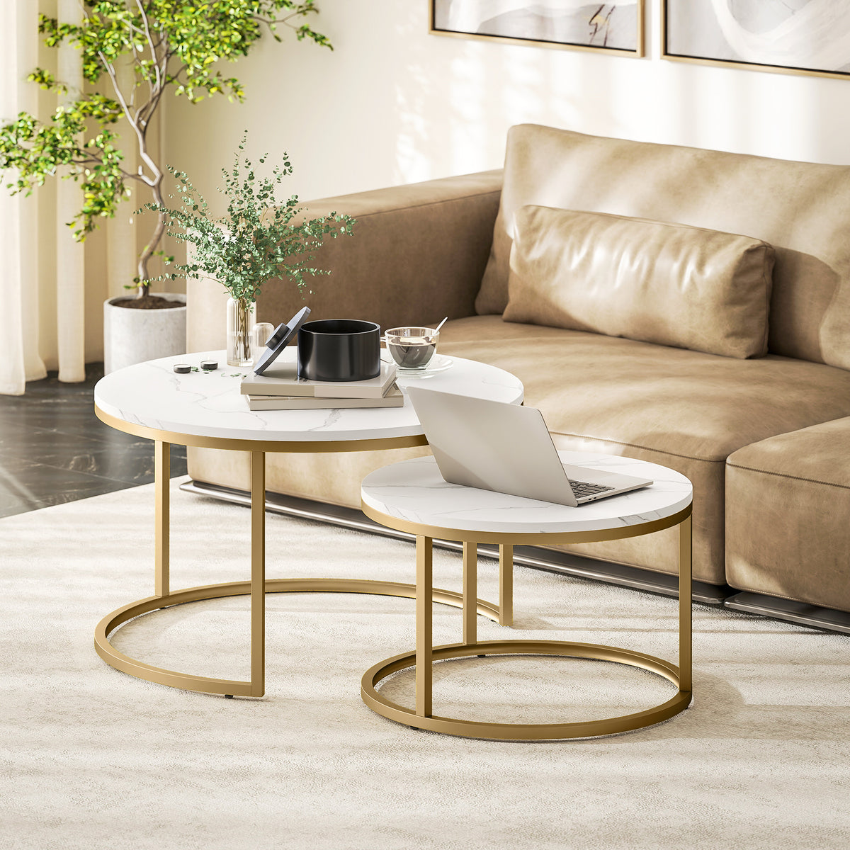 Nesting round coffee tables with marble-look tops and gold metal bases near sofa